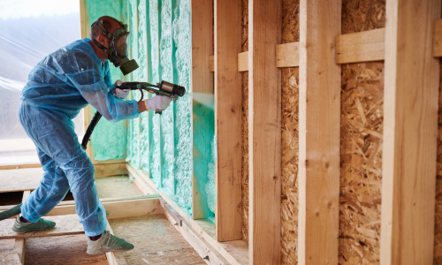 An individual spraying insulation